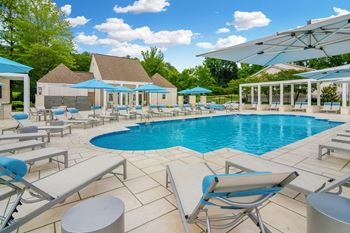 A swimming pool with chairs and umbrellas at the resort at governors residence club